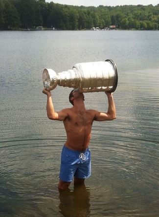 hockey players 2015 - Brandon Saad raises the Stanley Cup proudly while taking a dip in Indian Lake