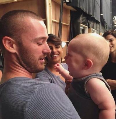 Jake McLaughlin with his baby on set of Quantico